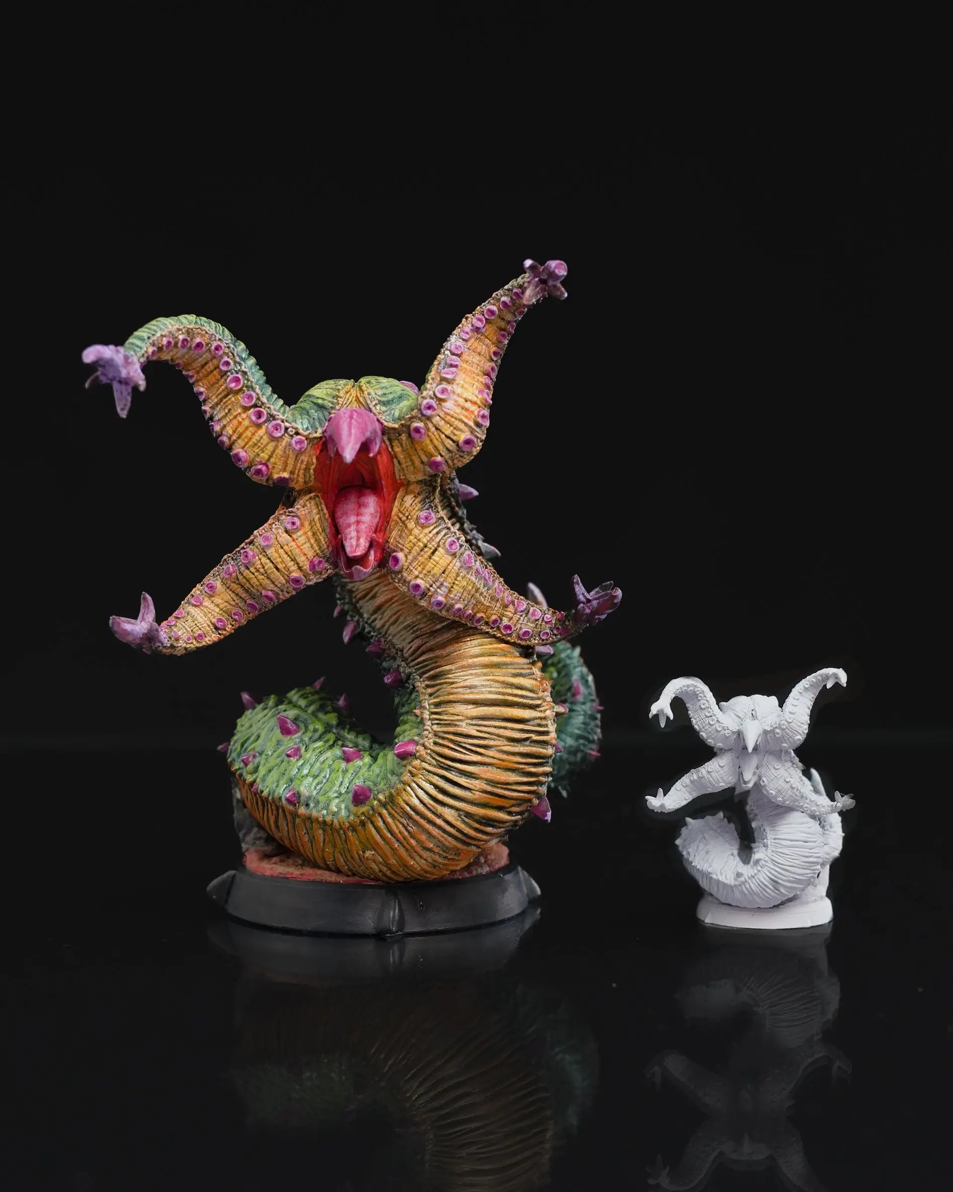 An unpainted and painted 3D printed Grick miniature for Dungeons & Dragons (DnD), featuring detailed tentacles, beaked mouth, and coiled serpent body on a display base. There is a comparison of the 75mm scale that is painted, and 32mm scale unpainted.