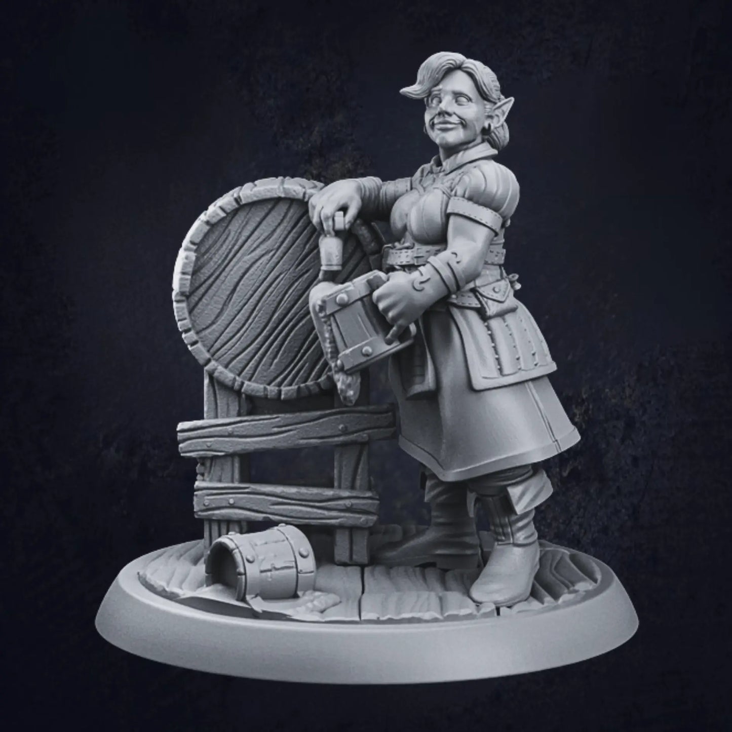 A miniature figurine of a female elven tavern keeper standing beside a large barrel. The figure wears medieval-style attire, including a belted tunic and boots, and holds a tankard in one hand. The other hand rests casually on the barrel, with a small bucket on the ground nearby. The figure is mounted on a textured, circular base, adding detail to the scene.