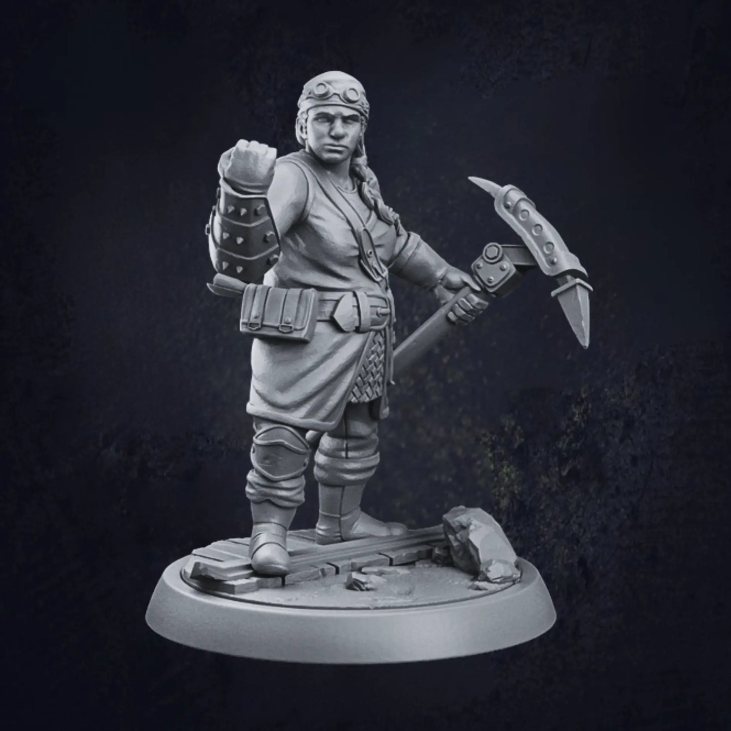 A detailed 3D-printed miniature of a female dwarven artificer, standing on a rocky circular base. The artificer is adorned in a tunic with a belt holding various pouches, paired with armored gauntlets and boots. She wields a large hammer or pickaxe in her right hand, while her left hand is raised in a clenched fist. The model showcases intricate craftsmanship, highlighting the artificer's robust and industrious character.