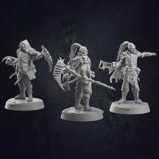 Three unpainted miniature figurines of dark fantasy characters, suitable for undead or vampire warriors, each posed menacingly. The figures wear gothic-style armor with intricate details, capes, and accessories. One wields a jagged scythe, another holds a massive, spiked axe, and the third gestures dramatically with a flared cloak. Their designs include skull motifs, tattered clothing, and fierce expressions, enhancing their eerie and powerful presence. Each stands on a textured round base.
