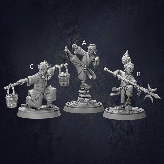 three figurines of characters, each with different poses and weapons, arranged in a row against a dark background.