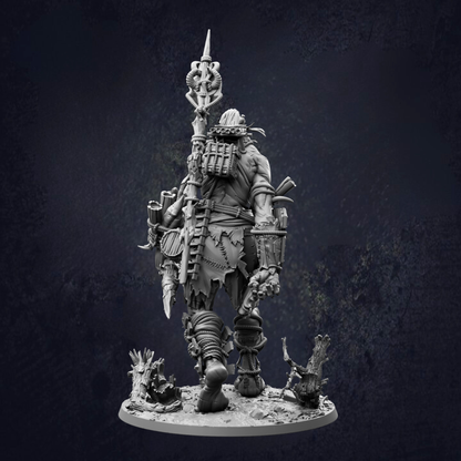 A detailed, dark-themed statue depicting a heavily armored and armed warrior figure, standing on a base and holding various weapons.