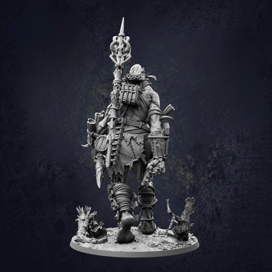 A detailed, dark-themed statue depicting a heavily armored and armed warrior figure, standing on a base and holding various weapons.