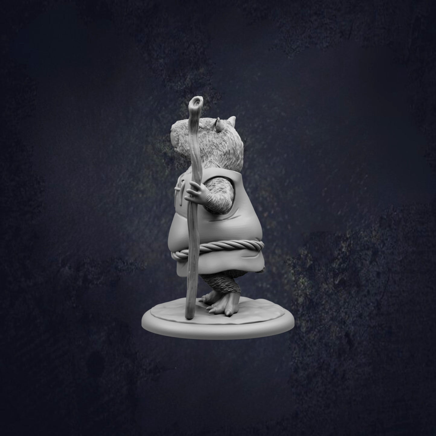 A statue of a mouse holding a stick and standing on a platform against a dark background.
