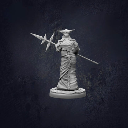 A statue of a person holding a spear and shield, standing in a dark, moody setting.