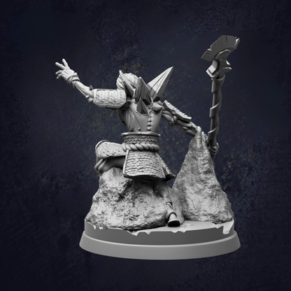 A 3D rendering of a warrior figure in a fighting stance, holding a spear and standing on a rocky outcrop.
