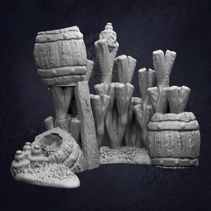 a collection of various sculptures and objects, including a barrel, a plant, and a small structure, all set against a dark background.