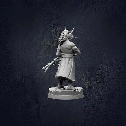 A statue of a muscular man with horns, standing on a pedestal and holding a weapon, against a dark background.
