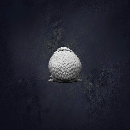 A white, spherical object resembling a ball or a small, round object is the central focus of the image, set against a dark, textured background.