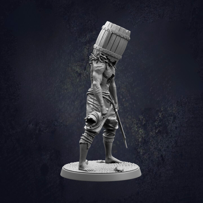 A statue of a person with a barrel on their head, standing on a platform.