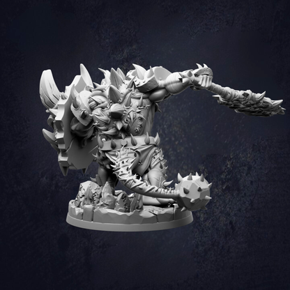 A detailed 3D model of a fierce-looking monster or dragon-like creature with sharp teeth and claws, standing on a rocky base and holding a large weapon.
