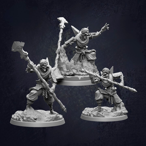 three figurines of characters, each holding a weapon and standing on a rocky base.