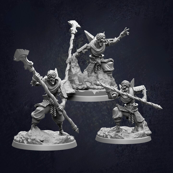 three figurines of characters, each holding a weapon and standing on a rocky base.