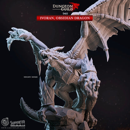 An unpainted 32mm scale dragon miniature, towering at 205mm in height. The dragon is posed majestically atop a jagged rock, with its massive wings spread wide. One claw grips the front of the rock, showcasing its dominance and power. The sculpt features intricate details, including sharp scales, curved horns, and a fierce expression, emphasizing the creature’s imposing presence. Ideal for any tabletop gaming session and an imposing boss.