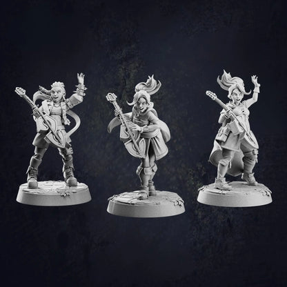 Three unpainted miniature figurines of fantasy female human bards, each holding a lute and posed dynamically. They wear detailed adventurer-style clothing with capes, boots, and various accessories. Each bard has a unique stance, with expressive faces and lively hair sculpted to suggest movement. The miniatures stand on round bases with engraved textures, against a dark, textured background.