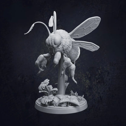 A highly detailed 3D-printed tabletop miniature of a giant bumblebee, poised mid-flight above a stylized floral base with daisies and leaves. The model is in grey resin and shows intricate textures on the wings, fur, and legs. Pictured is Pose A and designed by Dragon Trappers Lodge at 32mm scale.