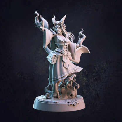 Model A - An unpainted 32mm scale miniature of a female Tiefling sorcerer by Cast N Play, standing on a 25mm round base. She is dynamically posed, holding a fiery spell in one hand while the other strikes out in front as if casting magic. Her flowing robes, curved horns, and intricate details emphasize her arcane power. The figure's stance and expression convey confidence and command over her sorcery.