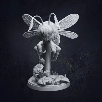 A highly detailed 3D-printed tabletop miniature of a giant bumblebee, poised mid-flight above a stylized floral base with daisies and leaves. The model is in grey resin and shows intricate textures on the wings, fur, and legs. Pictured is Pose B and designed by Dragon Trappers Lodge at 32mm scale.