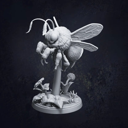 A highly detailed 3D-printed tabletop miniature of a giant bumblebee, poised mid-flight above a stylized floral base with daisies and leaves. The model is in grey resin and shows intricate textures on the wings, fur, and legs. Pictured is Pose E and designed by Dragon Trappers Lodge at 32mm scale.