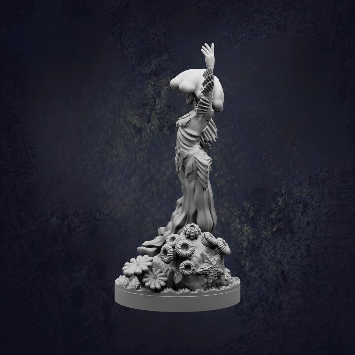 A white statue of a woman with her arms raised, standing on a base with flowers and plants.