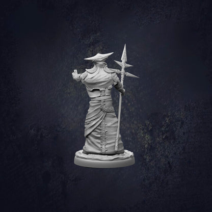 A statue of a person holding a spear and standing in a dark, moody setting.