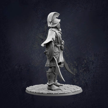 A statue of a warrior standing on a stone platform, holding a shield and sword.