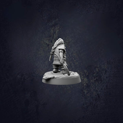 A small figurine of a person standing on a platform against a dark background.