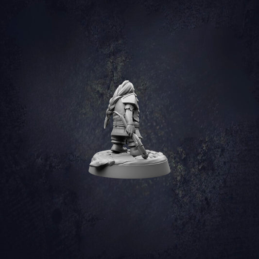 A small figurine of a person standing on a platform against a dark background.