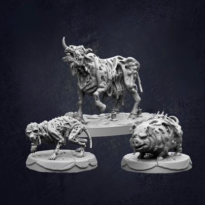 three sculptures of fantastical creatures, including a large, monstrous bull-like creature, a smaller, monstrous creature, and a pig-like creature.