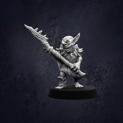 A small, detailed figurine of a fantastical creature, possibly a gnome or elf, holding a weapon and standing on a platform against a dark background.