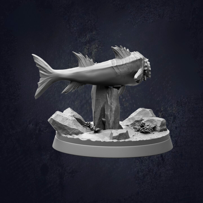 A 3D model of a fish sculpture is displayed on a rock base against a dark background.