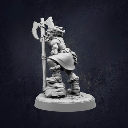 A 3D model of a warrior figure holding a large weapon, standing on a rock formation.