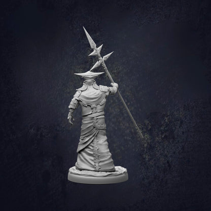 A statue of a person holding a spear and a shield, standing in a dark, moody setting.